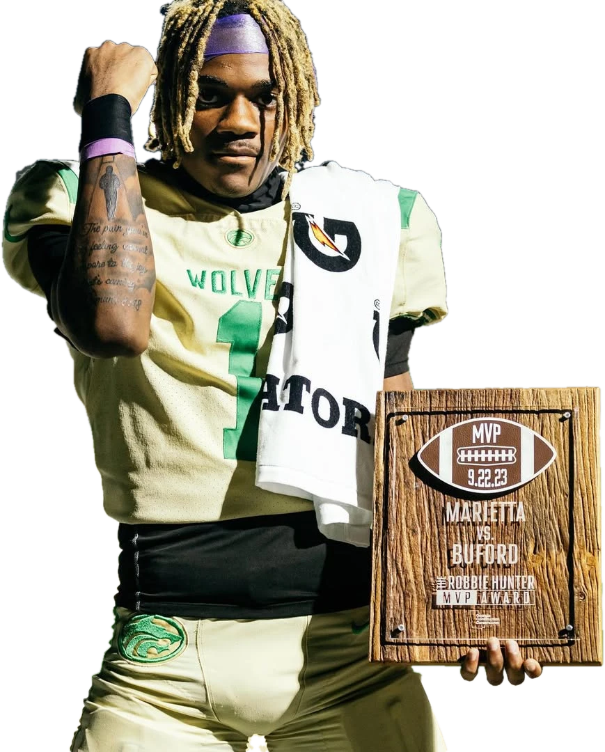 KJ Bolden in his Buford uniform holding a game MVP plaque