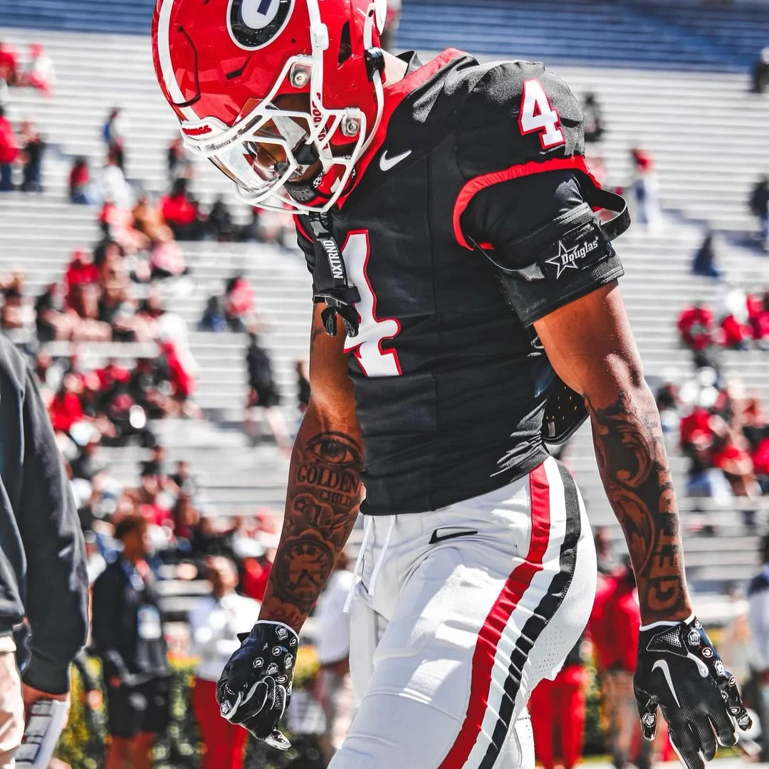 KJ Bolden in Georgia's black number 4 jersey, head down before kickoff