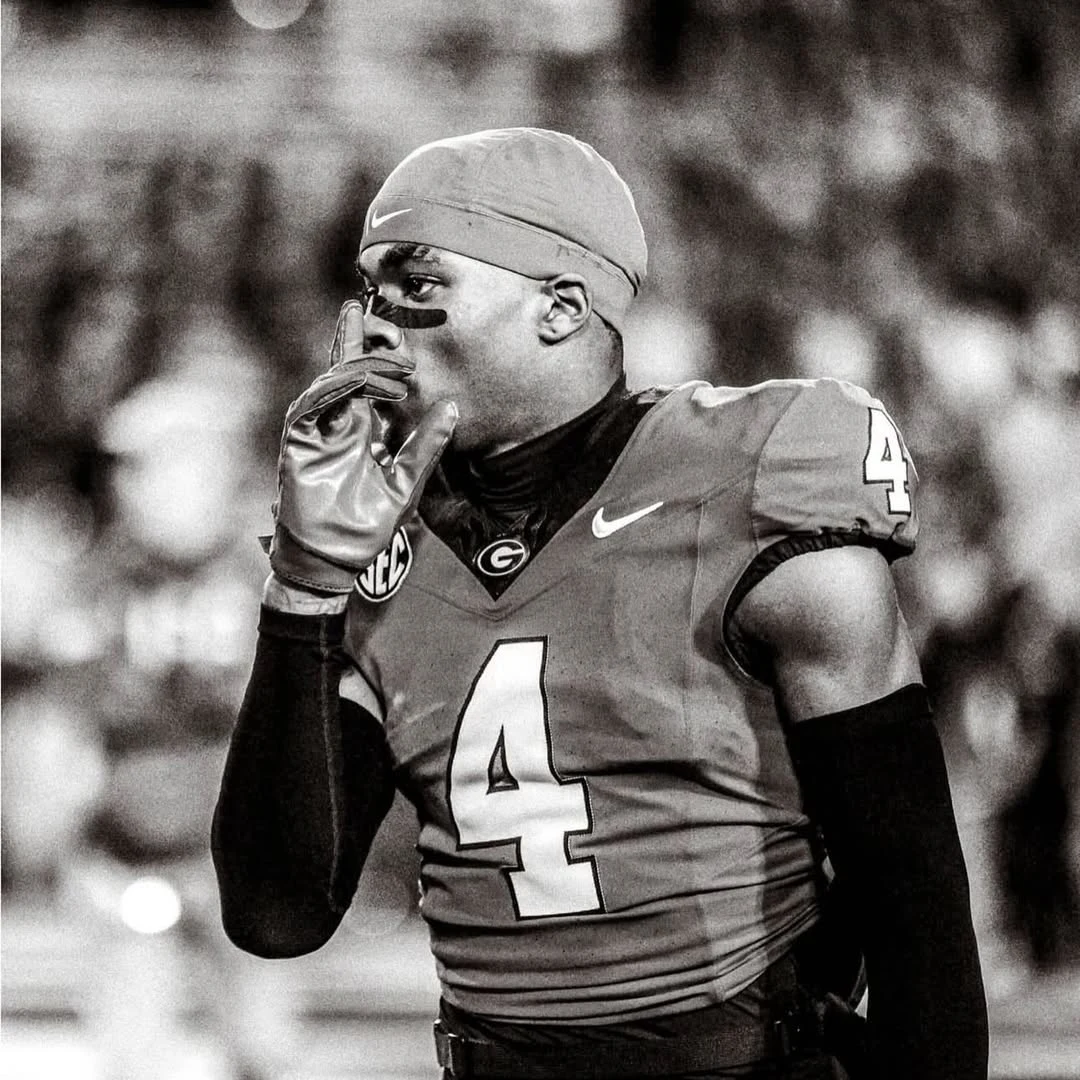 KJ Bolden on the sideline in his number 4 jersey, hand at his chin